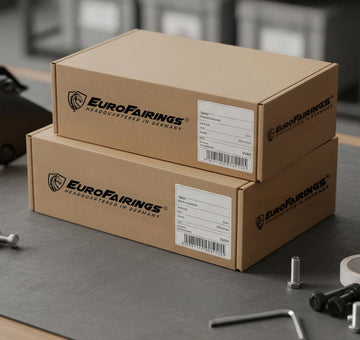 Two Eurofairings boxes on a workbench with tools and hardware.